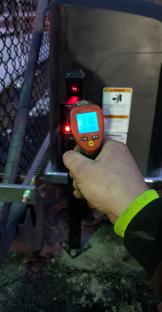 A thermal thermometer taking the reading of the steel post the heated photo eye is mounted on. The temperature is 31.8 degrees Fahrenheit