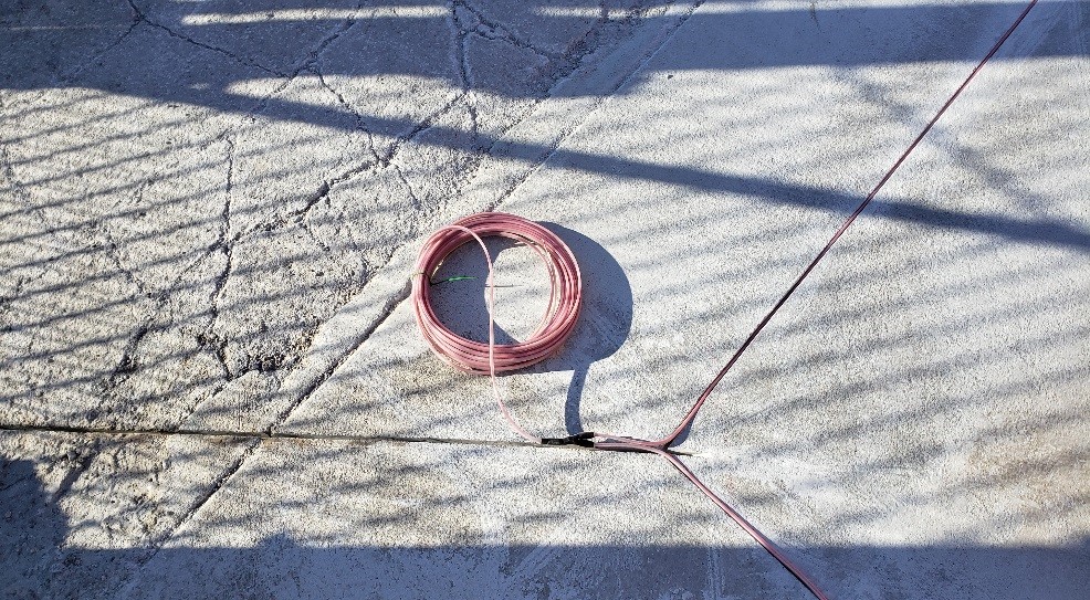 Preformed loop installed in the rectangular groove in a driveway for an exit loop for gate