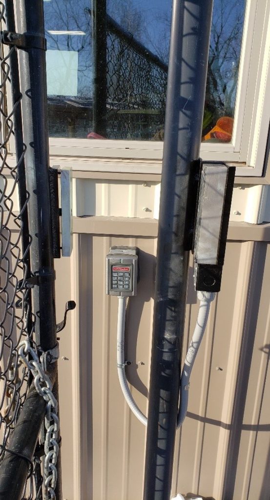 Side view of a maglock with a keypad installed on one side of the gate