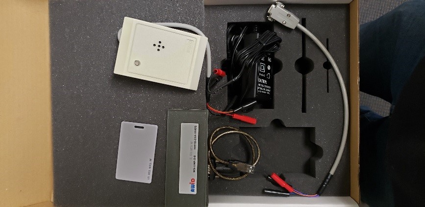 AWid LR3000 TEK kit for a proximity reader with a beeper, power supply, windshield tag, a card, a USB adapter and alligator clips