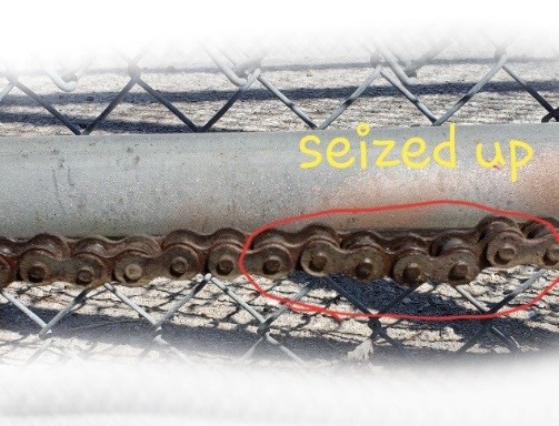 Close up of a slide gate operator chain that has seized up
