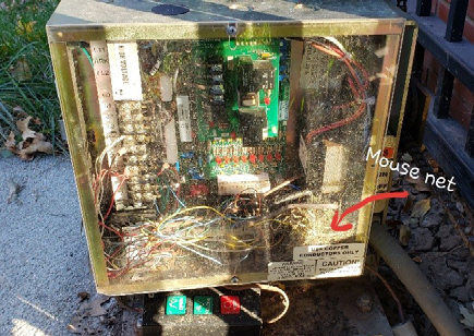 The inside of a gate operator with a mouse nest inside