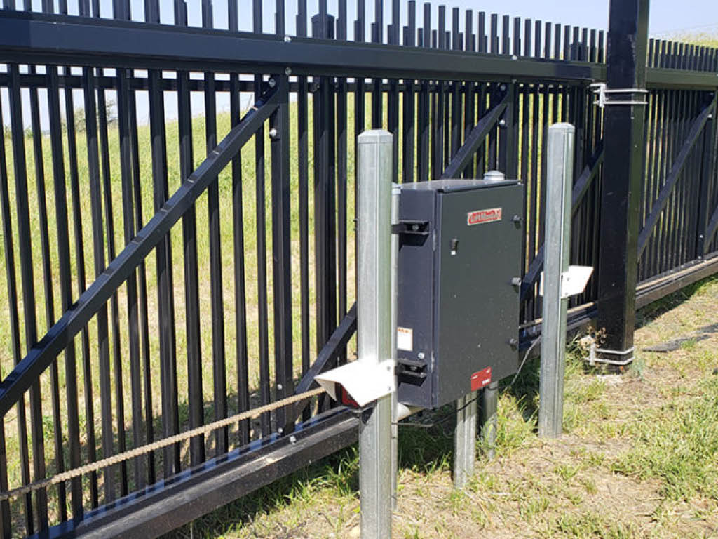 Black cantilever slide gate with operator. 

access control Sioux Falls, South Dakota commercial gate installation company automated electric gate opener operators solar motor motorized automatic access control driveway estate slide swing rolling cantilever vertical lift vertical pivot open close stop key pad switch push button three button control intercom call button telephone entry computerized entry loop exit obstruction shadow detector transmitter receiver radio frequency wifi box cantilever aluminum 